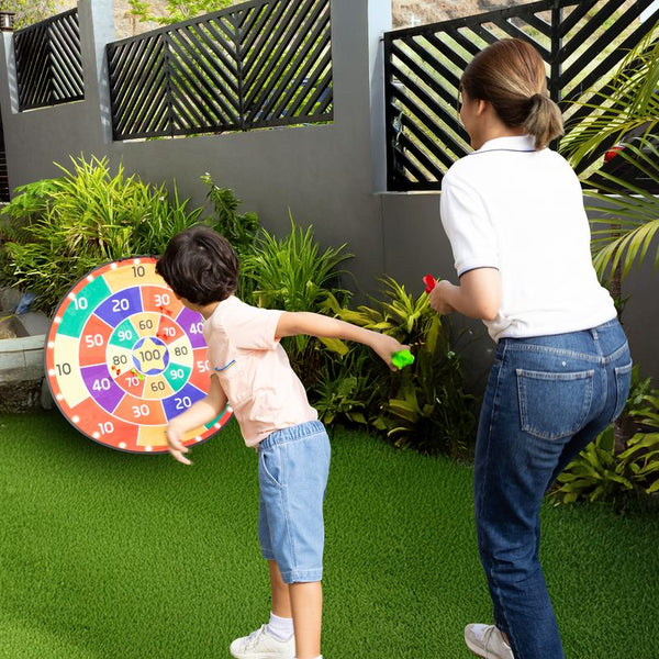 A boy throwing at the board on a garden wall
