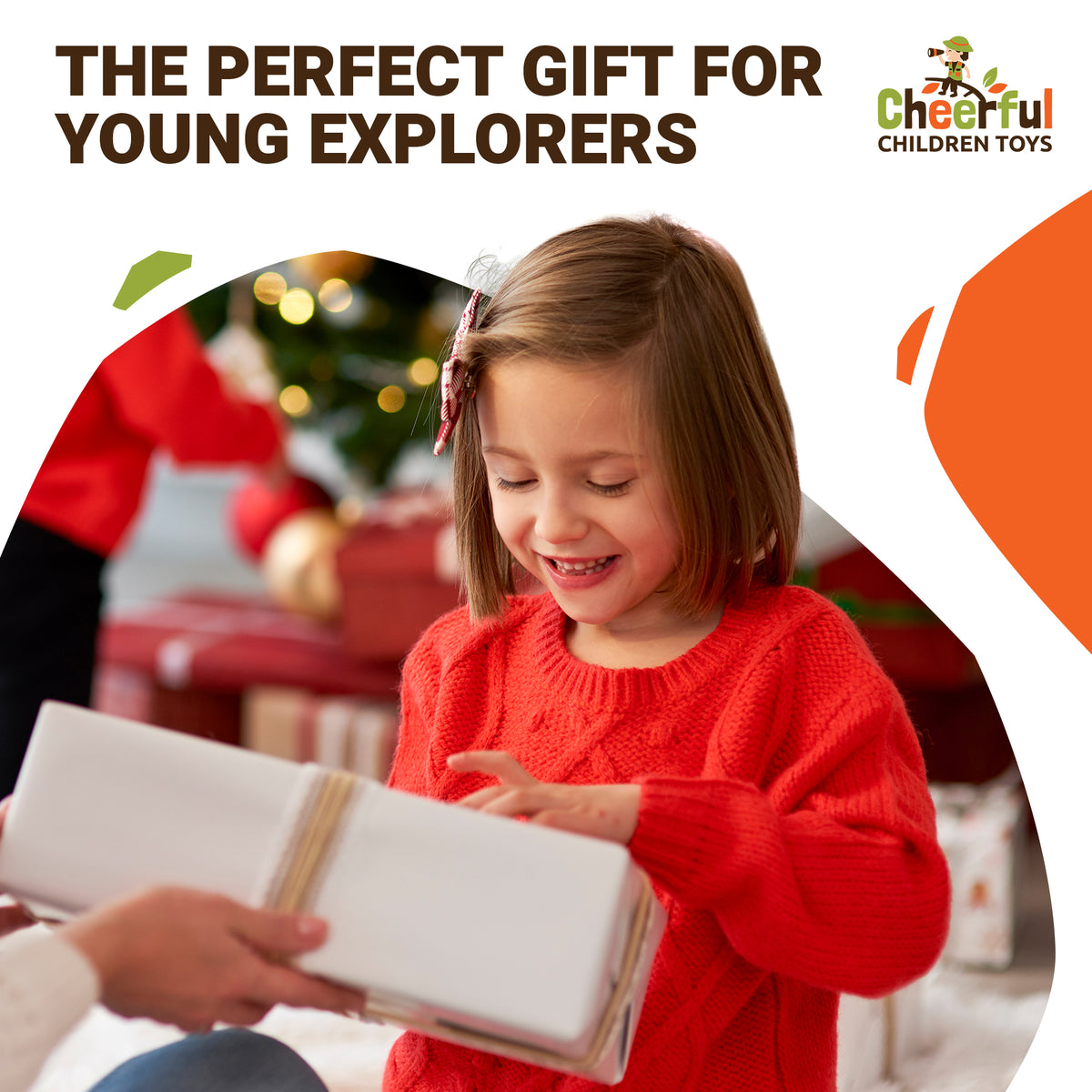 Girl in a red jumper opening a present by the Christmas tree