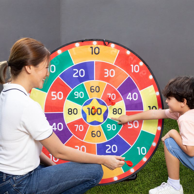 A mum and her son pointing at the numbers on the board, adding up the score
