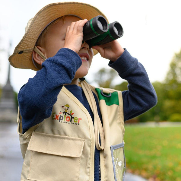 Boy looking through the binoculars in the park