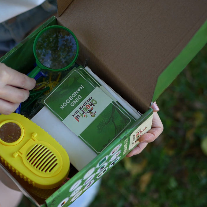 The explorer kit box opened, with the bug jar, magnifier and handbook inside