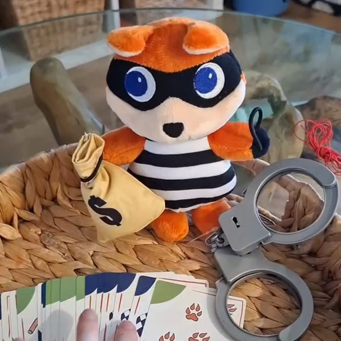 The fox bandit plush with his money bag, handcuffs and clue cards