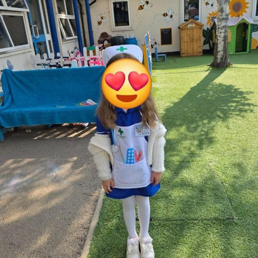 A customer photo: a girl at nursery in the full nurse set
