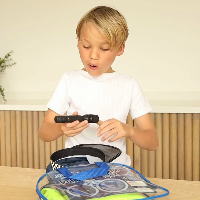 Boy unboxing the police costume set bag and trying the torch
