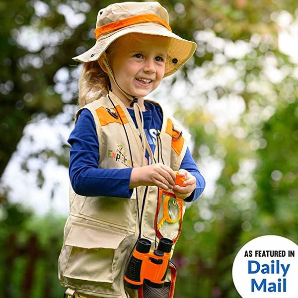 Child exploring outdoors in an orange explorer vest and hat