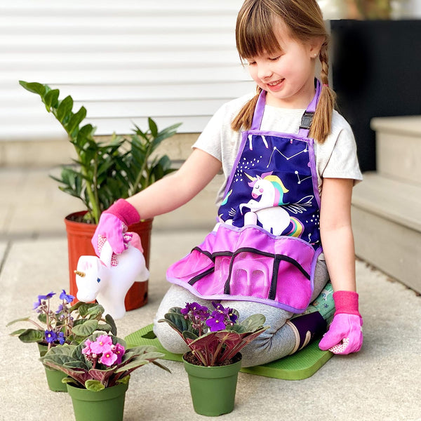 Child using the unicorn gardening kit to water plants